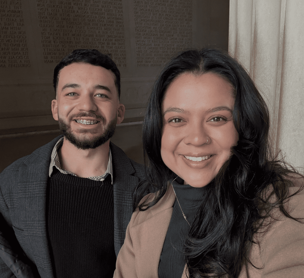 Siblings smile at the camera.